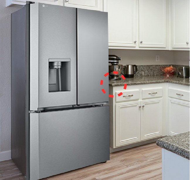 A kitchen highlighting a refrigerator with a countertop directly next to it.